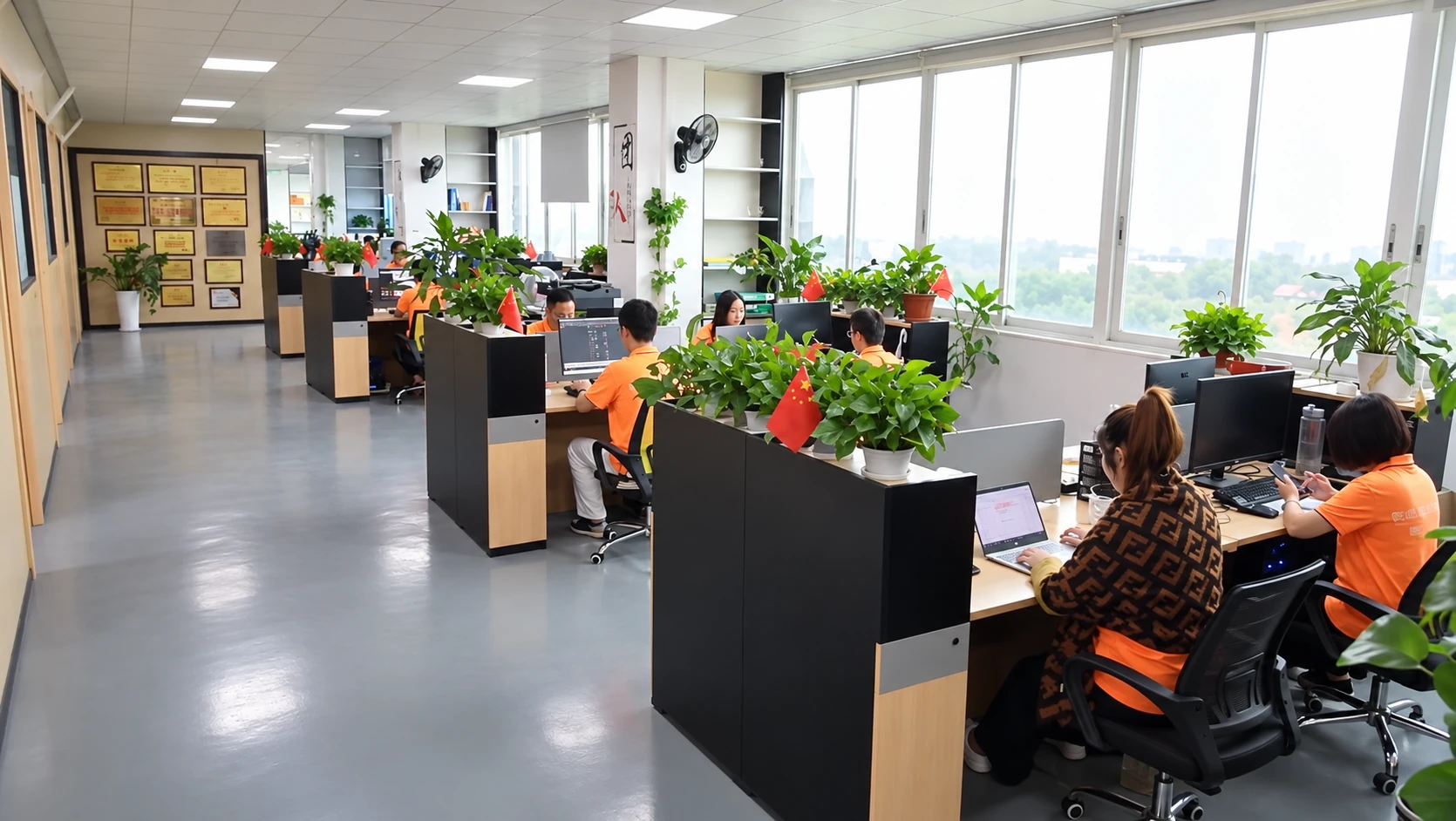 Office environment with project desks, computers and a central aisle