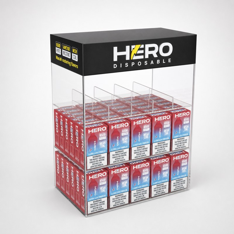 Partially stocked clear acrylic disposable vape display with a black header and compartment dividers, left front view.