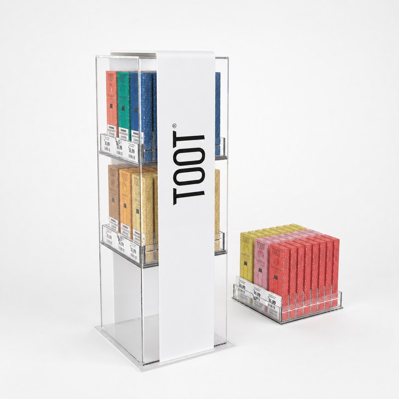 Partially stocked clear acrylic vape display set combining a three-tier upright stand and a single-tier counter stand, combined view.